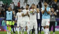 Iran’s Ehsan Hajsafi (centre) and teammates salute the spectators. AFP