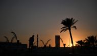 A view of the sun setting over Doha Corniche. (Pic by Hector Retamal/AFP)