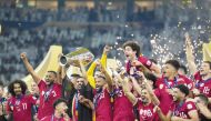 Qatar players celebrate with the trophy on Saturday night.