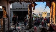 People inspect debris and rubble in a building heavily damaged by Israeli bombardment, in Rafah in the southern Gaza Strip on February 11, 2024. Photo by SAID KHATIB / AFP