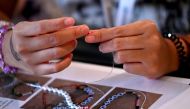 Delegates take part in a bracelet-making event during the Taylor Swift 