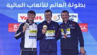 Gold medallist US’ Nic Fink (centre), silver medallist Italy’s Nicolo Martinenghi (left) and bronze medallist Britain’s Adam Peaty pose on the podium of the men’s 100m breaststroke yesterday. 