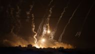 This picture taken from the Israeli side of the border with Gaza on November 10, 2023, shows smoke and flares dropped by Israeli forces over the Gaza Strip. (Photo by Kenzo TRIBOUILLARD / AFP)
