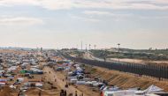 Displaced Palestinians camp near the border fence between Gaza and Egypt, on February 16, 2024 in Rafah, in the southern Gaza Strip. (Photo by Mohammed Abed / AFP)