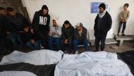 Palestinians gather to identify the bodies of relatives Rafah's Al-Najjar hospital on February 18, 2024, following overnight Israeli air strikes on the southern Gaza Strip.