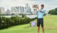 Spain's David Puig poses with the trophy after winning the final round of the Malaysian Open at the Mines Resort and Golf Club in Seri Kembangan on February 18, 2024. (Photo by Arif Kartono / AFP)