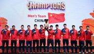 China's men players celebrate with the trophy after winning against Malaysia at the 2024 Badminton Asia Team Championships in Shah Alam, Selangor, on February 18, 2024. (Photo by Mohd RASFAN / AFP)