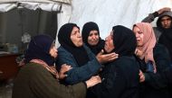 People mourn relatives killed in overnight Israeli bombardment, outside the Al-Najjar hospital in Rafah in the southern Gaza Strip on February 23, 2024. (Photo by Mohammed Abed / AFP)