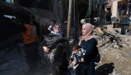 Palestinians flee their homes along with their belongings following Israeli bombardment in Rafah in the southern Gaza Strip on February 24, 2024, amid continuing battles between Israel and the Palestinian militant group Hamas. (Photo by MOHAMMED ABED / AFP)
