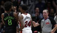 Naji Marshall #8 of the New Orleans Pelicans and Jimmy Butler #22 of the Miami Heat are involved in an altercation during the fourth quarter of an NBA game at Smoothie King Center on February 23, 2024 in New Orleans, Louisiana. (Photo by Sean Gardner / GETTY IMAGES NORTH AMERICA / Getty Images via AFP)
