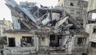 Palestinians search the rubble of their house which was destroyed in an overnight Israeli air strike in the Rafah refugee camp in the southern Gaza Strip on February 27, 2024. (Photo by Said Khatib / AFP)
