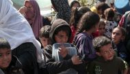 Displaced Palestinians gather for food in Rafah, on the southern Gaza Strip on February 28, 2024. (Photo by AFP)