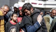 People mourn following an early morning incident when residents rushed toward aid trucks in Gaza City on February 29, 2024. Photo by AFP