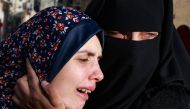 Rania Abu Anza (L) the mother of twin babies Naeem and Wissam, killed in an overnight Israeli air strike, mourns their death ahead of their burial in Rafah in the southern Gaza Strip on March 3, 2024, as the conflict between Israel and the Palestinian militant group Hamas continues. (Photo by MOHAMMED ABED / AFP)
