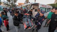 An injured man is stretchered into Al-Aqsa hospital in Deir al-Balah in central Gaza on March 3, 2024, amid the ongoing battles between Israel and the Palestinian Hamas group. (Photo by AFP)
