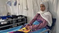 This picture taken on March 6, 2024 shows 15-year-old Palestinian girl Hala Hazem Hamada taking rest inside a hospital in Rafah. The Israeli attack claimed the lives of Hala's six relatives including her parents. (Photo by Said Khatib / AFP)