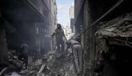 Palestinians inpect the rubble of a building in Deir el-Balah following Israeli bombardment, in the central Gaza Strip, on March 8, 2024, amid ongoing battles between Israel and Hamas. (Photo by AFP)
