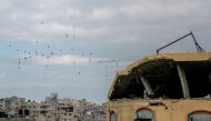 Aid parcels are airdropped over the northern Gaza Strip on March 8, 2024. (Photo by AFP)