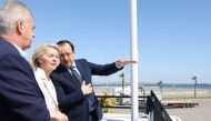 A handout picture provided by the Cypriot government's Press and Information Office (PIO) shows Cyprus' President Nikos Christodoulides (R) and President of the European Commission Ursula von der Leyen inspecting the Larnaca Port, in Larnaca, Cyprus. (Photo by Andreas Loucaides / PIO / AFP)