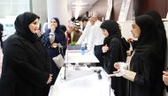 Assistant Undersecretary for Educational Affairs Maha Zayed Al Ruwaili (left) interacting with an exhibitor at the event.