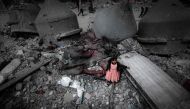 A Palestinian girl wearing a pink dress stands amidst the ruins of the Al-Faruq Mosque that was destroyed during Israeli bombardment, in Rafah on the southern Gaza Strip on March 22, 2024. (Photo by Mohammed Abed / AFP)