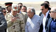 UN Secretary-General Antonio Guterres (C) walks on the tarmac, upon landing at Egypt's al-Arish Airport, near the Rafah border with the Gaza Strip on March 23, 2024. (Photo by Khaled Desouki / AFP)