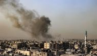 Smoke billows over buildings following Israeli bombardment in Rafah in the southern Gaza Strip on March 27, 2024. (Photo by SAID KHATIB / AFP)
