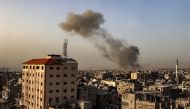 Smoke billows over buildings following Israeli bombardment in Rafah in the southern Gaza Strip on March 27, 2024. (Photo by SAID KHATIB / AFP)
