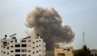 Smoke rises above buildings during an Israeli strike in the vicinity of the al-Shifa hospital in Gaza City on March 28, 2024. (Photo by AFP)