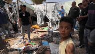 Palestinians check the damage at a makeshift camp for displaced people in front of the Al-Aqsa Martyrs Hospital in Deir al-Balah in the central Gaza Strip, after it was hit by Israel bombardment on March 31, 2024. (Photo by AFP)
 