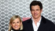 Mercedes team principal Toto Wolff (R) and his wife Swiss pilot Susie Wolff pose on the red carpet upon arrival for the UK premier of 