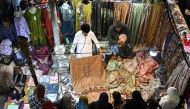 People shop clothes at a market in Karachi on April 5, 2024, ahead of Eid al-Fitr celebrations which marks the end of the Muslim holy month of Ramadan. (Photo by Asif HASSAN / AFP