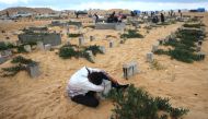 A man visits the grave of a loved one at the start of the Eid Al Fitr festival, marking the end of the Muslim holy month of Ramadan, at a cemetery in Rafah in the southern Gaza Strip, on April 10, 2024. (Photo by AFP)

