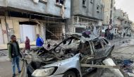 Onlookers check the car in which three sons of Ismail Haniyeh were reportedly killed in an Israeli air strike in al-Shati camp, west of Gaza City on April 10, 2024. (Photo by AFP)