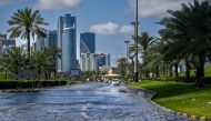 A picture shows a flooded street following heavy rains in Sharjah on April 17, 2024. (Photo by Ahmed RAMAZAN / AFP)
