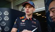 Red Bull Racing's Dutch driver Max Verstappen signs an autograph at the Shanghai International circuit ahead of the Formula One Chinese Grand Prix in Shanghai on April 18, 2024. (Photo by Pedro Pardo / AFP)