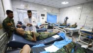 iraqi military personnel receive treatment at a hospital in Hilla in the central province of Babylon after they were wounded in an alleged bombing overnight on an iraqi military base housing a coalition of pro-Iranian armed groups, on April 20, 2024. (Photo by Karar Jabbar / AFP)
