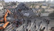 Palestinians inspect the rubble of a building hit in overnight Israeli bombing in Rafah, in the southern Gaza Strip, on April 21, 2024. (Photo by Mohammed Abed / AFP)