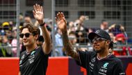 Mercedes' British driver George Russell (L) and Mercedes' British driver Lewis Hamilton (R) arrive ahead of the Formula One Chinese Grand Prix race at the Shanghai International Circuit in Shanghai on April 21, 2024. (Photo by PEDRO PARDO / AFP)