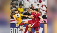 Qatar and Australia players in action during their last Group A match. 