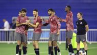 Qatar players share a light moment during team’s training session ahead of the quarter-final.