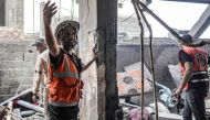 First responders search a building following Israeli bombardment in Nuseirat in the central Gaza Strip on April 29, 2024. (Photo by AFP)
