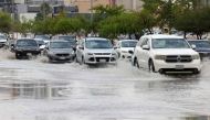 Cars drive through standing water in the Saudi capital Riyadh following strong winds and heavy rain overnight that flooded roads in different regions of the desert kingdom on May 1, 2024. (Photo by Fayez Nureldine / AFP)