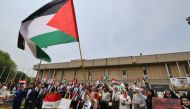 Iraqi university students and professors carrying Palestinian flags rally at Al-Nahrain University in Baghdad on May 2, 2024 in solidarity with Gaza and pro-Palestinian protests at US universities. Photo by AHMAD AL-RUBAYE / AFP.