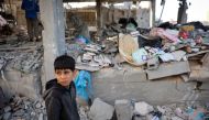 A Palestinian child stands in front of a building destroyed by Israeli bombing in Rafah in the southern Gaza Strip on May 3, 2024. (Photo by AFP)
