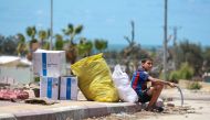 Displaced Palestinians who left with their belongings from Rafah in the southern Gaza Strip following an evacuation order by the Israeli army, unload their belongings to set up shelter in Khan Yunis on May 6, 2024. Photo by AFP.