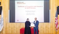 Fatma Wael Al Emadi, from Al Maha Academy for Girls, receiving her honours certificate from Dr. Rachid Bendriss (right).