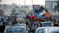 Displaced Palestinians flee Rafah with their belongings to safer areas in the southern Gaza Strip on May 7, 2024. (Photo by AFP)