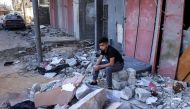 A boy sits amidst rubble at the site of a building that was hit by Israeli bombardment in Rafah in the southern gaza Strip on May 8, 2024. (Photo by AFP)