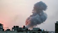 Smoke rises above buildings during an early morning Israeli strike on Rafah in the southern Gaza Strip on May 11, 2023. (Photo by AFP)